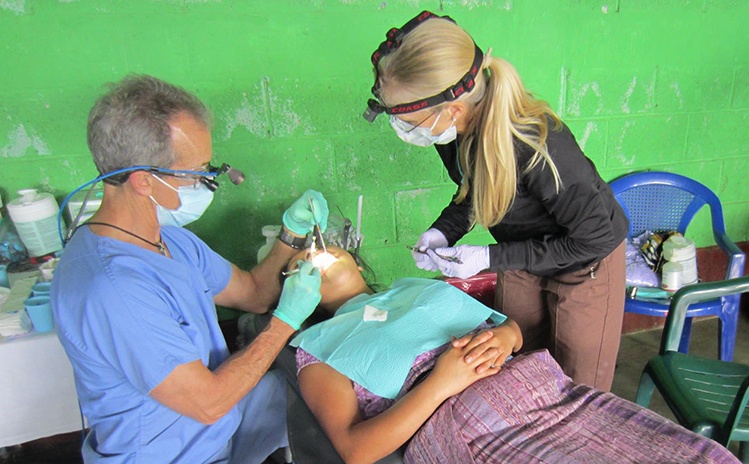 Dentist treating patient on mission