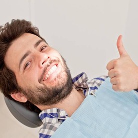 Man with thumb up dental visit