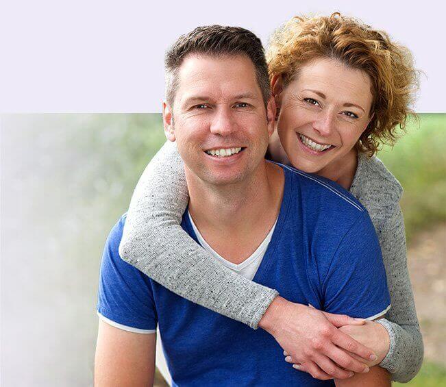 Smiling man and woman outdoors