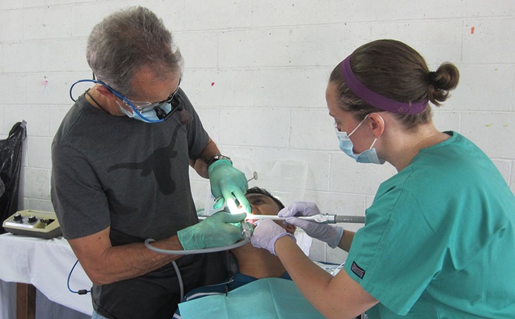Dentist and team member treating patient on mission trip