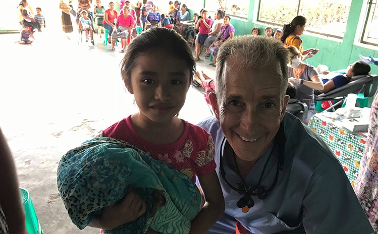 Dentist posing with child