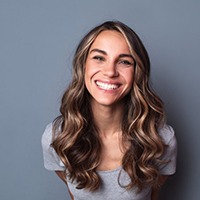 woman smiling after getting dental crowns in Mesquite (for crowns page intro)