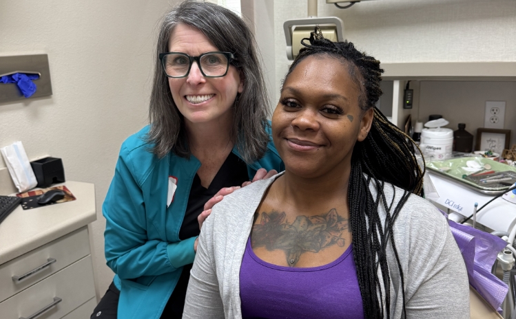 Two dental professionals posing together in a treatment room
