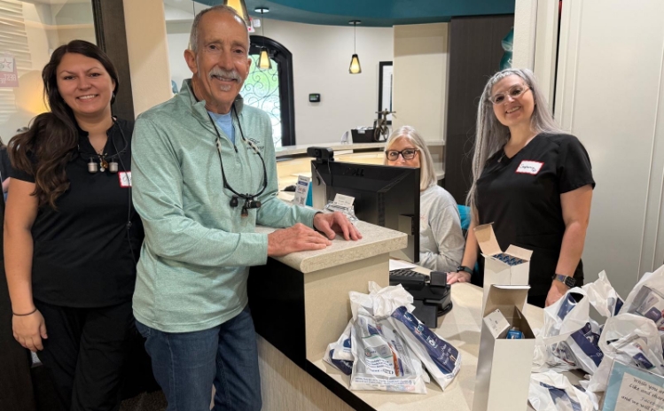 Two women smiling and posing together in a dental office