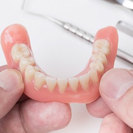 Dentist holding AvaDent Digital Dentures