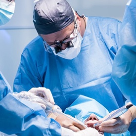 an oral surgeon performing dental implant surgery