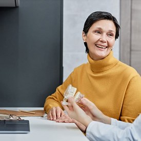 Dental patient talking with dental team member