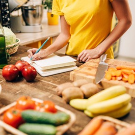 a person preparing fresh vegetables for a recipe