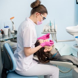 a dental hygienist cleaning a patient’s teeth