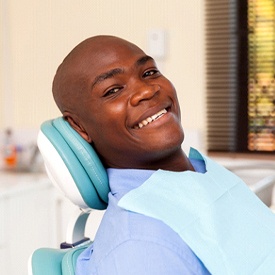 A male patient smiling after receiving his metal-free restoration in Mesquite