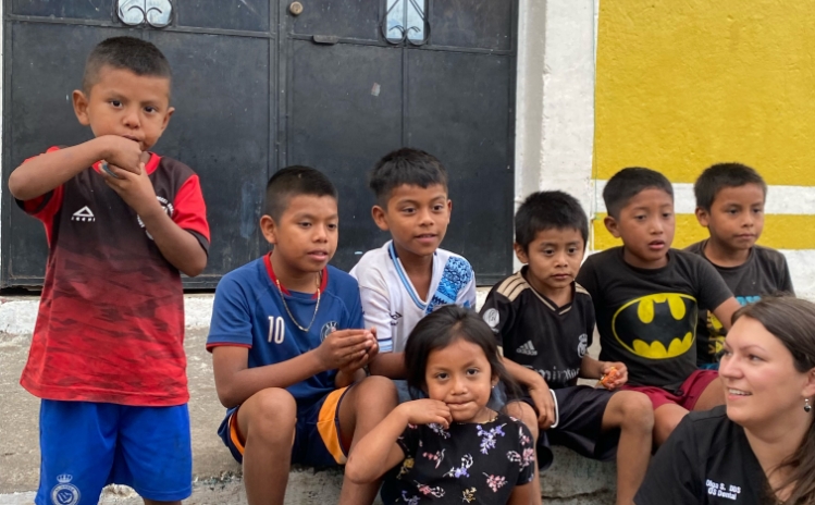 Group of children and adults holding toothbrushes during a community outreach event