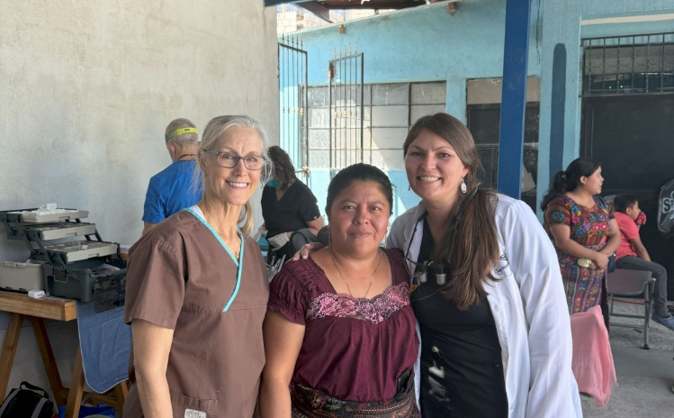 Dental professionals providing treatment to a patient in a portable clinic