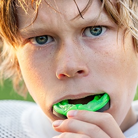 Teen boy placing sportsguard