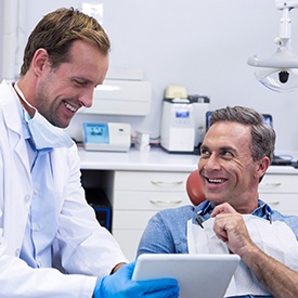 Dentist and patient discussing the details of full mouth reconstruction