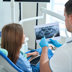 dentist pointing out infected tooth 