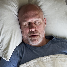 Man sleeping soundly in bed