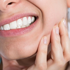 Closeup of patient holding jaw in pain