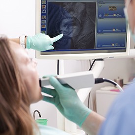 Woman and dentist looking at intraoral photos