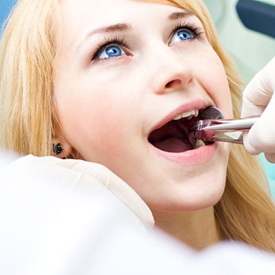 girl getting tooth extraction