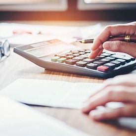 Patient using calculator to determine cost at desk