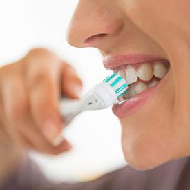 Woman brushing teeth