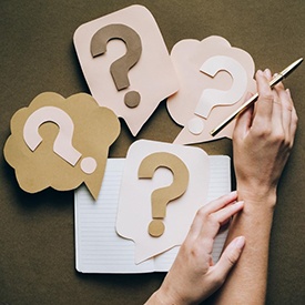 Woman with question cards and notebook.