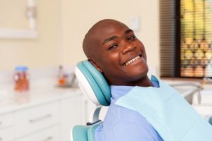 young man dental chair smiling