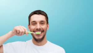 Smiling man practicing good dental habits