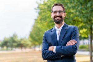 Confident businessman smiles after teeth whitening in Mesquite 